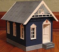 The Lewis Gingerbread House, repainted blue and white.  Click to go to article.
